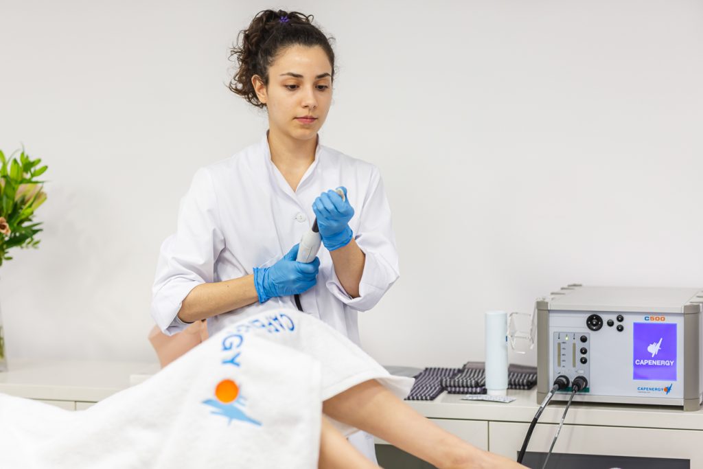 Healthcare professional in a modern clinic offering advanced Capenergy technology for male pelvic floor rehabilitation after prostatectomy